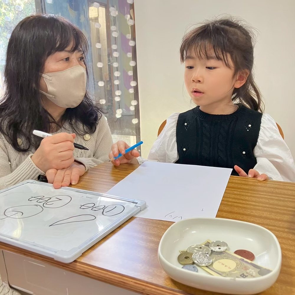 A child working with a teacher in the exam-prep class