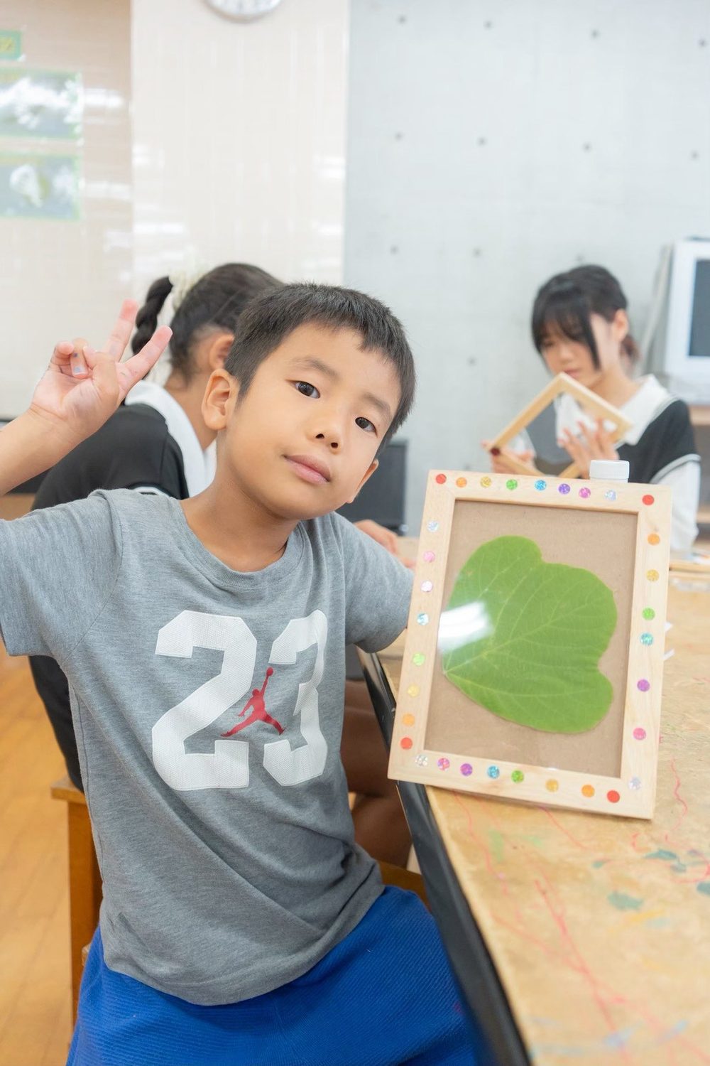 サマースクール:机に向かって英語のワークシートに取り組む子どもたち